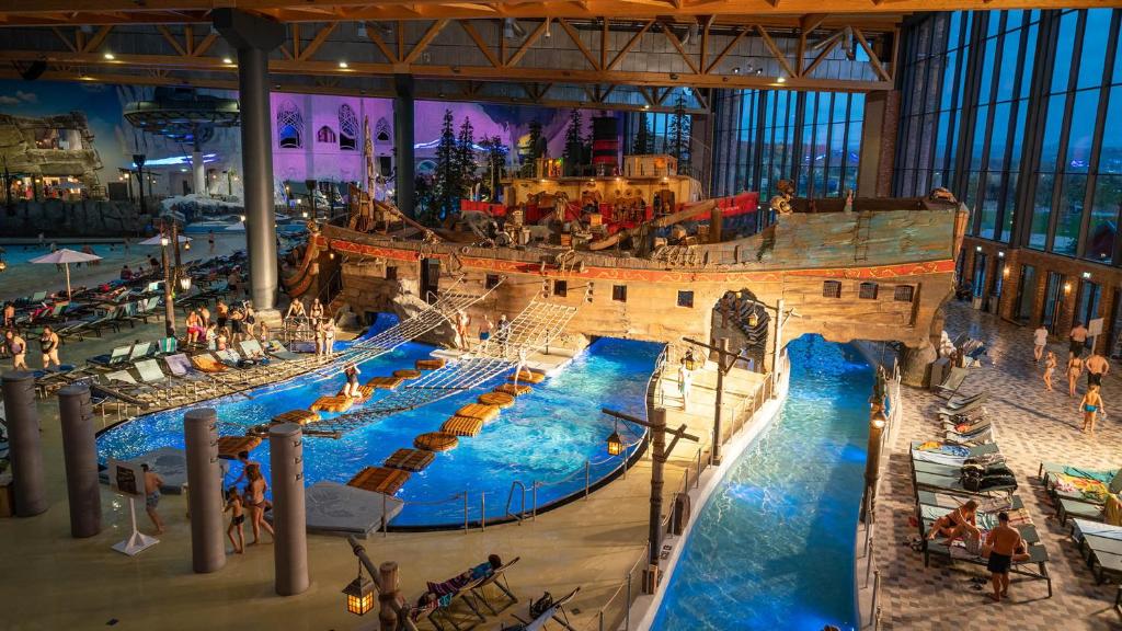 un grand parc aquatique intérieur avec un bateau pirate dans l'établissement MOBIL HOME familiale EN ALSACE11 KM DES GRANDS PARCS, à Boofzheim