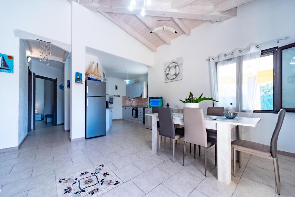 une cuisine et une salle à manger avec une table et des chaises dans l'établissement Villa Tiziana&Alessia, à Castiadas