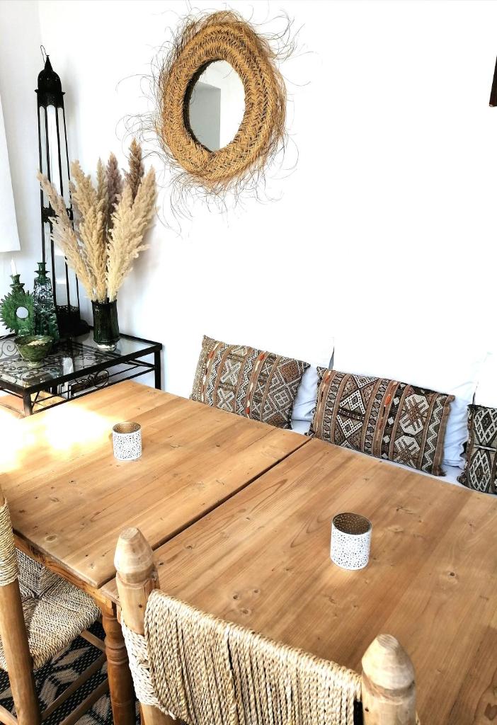 - une table à manger en bois avec des chaises et un miroir dans l'établissement Riad Dar Nouba, à Marrakech