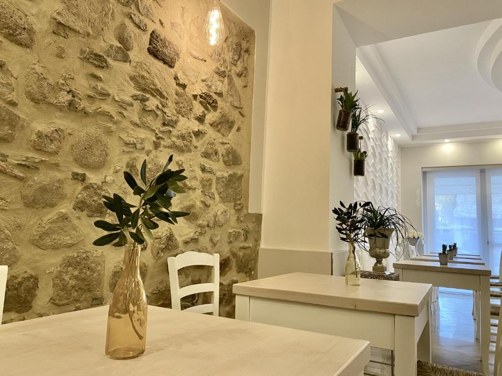 une cuisine et une salle à manger avec un mur en pierre dans l'établissement Albergo Elea, à Ascea
