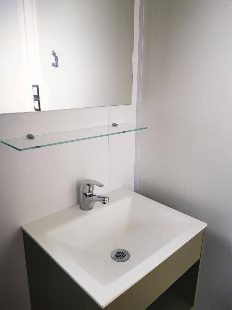 une salle de bain avec un lavabo et un miroir dans l'établissement Mobil home 8 personnes camping l ile d or saint raphael, à Saint-Raphaël