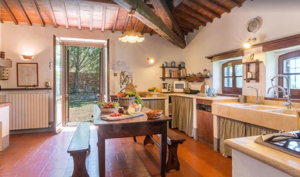 une grande cuisine avec une table et un évier dans l'établissement Exclusive Villa Parrano - countryside with pool, à Parrano