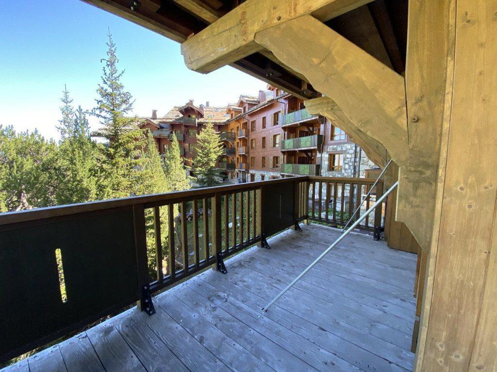 - un balcon d'une maison avec une balustrade en bois dans l'établissement Stylish ski-in ski-out 3 bed apartment, Arc 1950, à Arc 1950