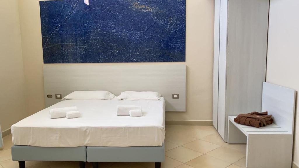 une chambre avec deux lits et un tableau au mur dans l'établissement Toscana Sport Resort, à Tirrenia