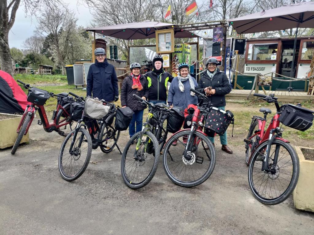Un groupe de personnes debout à côté de leurs vélos dans l'établissement Lisbeth 1902, à Malestroit