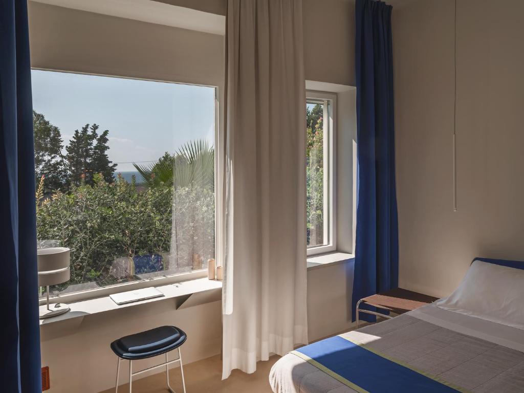 une chambre avec un lit et une grande fenêtre dans l'établissement Kubo Sea Views Luxury Escape, à Lecce