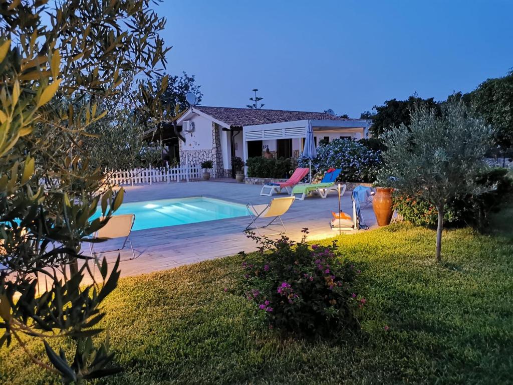 une maison avec une piscine dans une cour dans l'établissement VILLA HIBISCUS, à Castellammare del Golfo