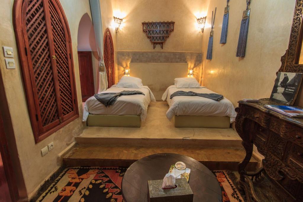 une chambre avec deux lits et une table dans l'établissement Riad Zen House, à Marrakech 32 autres photos