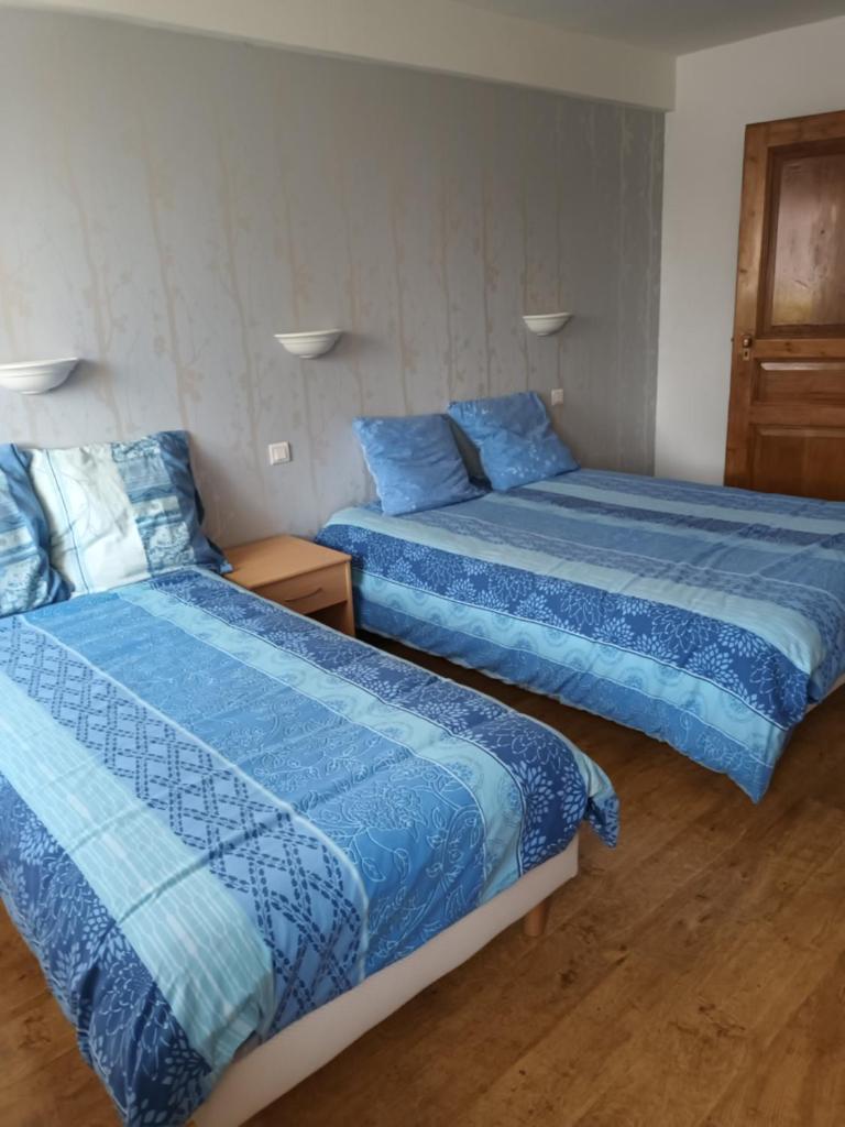 deux lits côte à côte dans une chambre dans l'établissement Gite du Berger, à Brouviller
