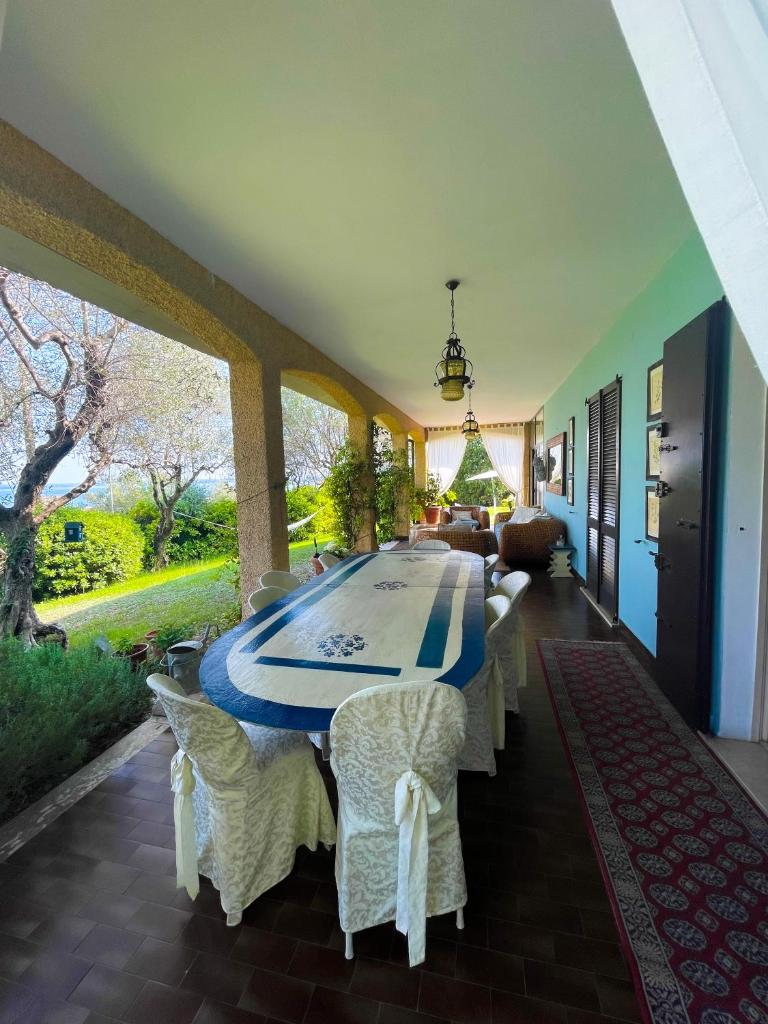 une salle à manger avec une longue table et des chaises dans l'établissement Villa con vista lago e piscina, à Moniga del Garda