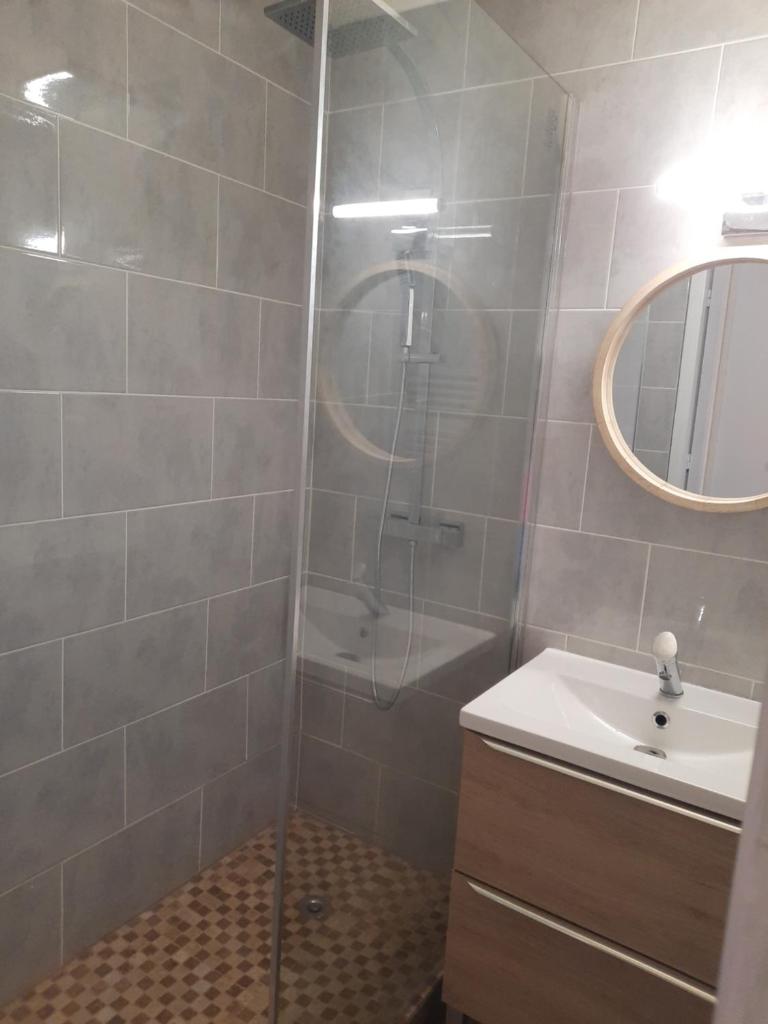 une salle de bain avec une douche, un lavabo et un miroir dans l'établissement appart entierement renové les coches - la Plagne, à Bellentre