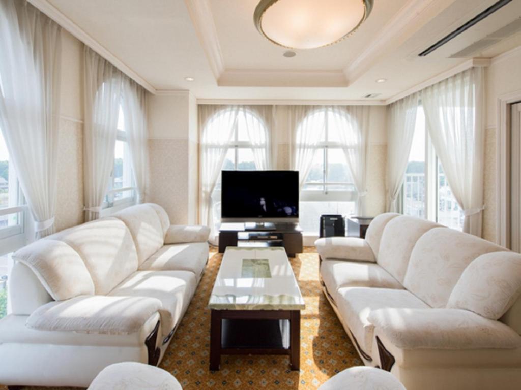 Il comprend un salon doté de canapés blancs et d'une télévision à écran plat. dans l'établissement Spa Resort LiVEMAX, à Mooka