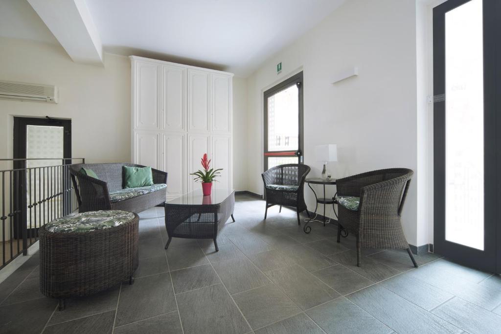 un salon avec des chaises et une table dans l'établissement Hotel Residence Laigueglia free parking, à Laigueglia