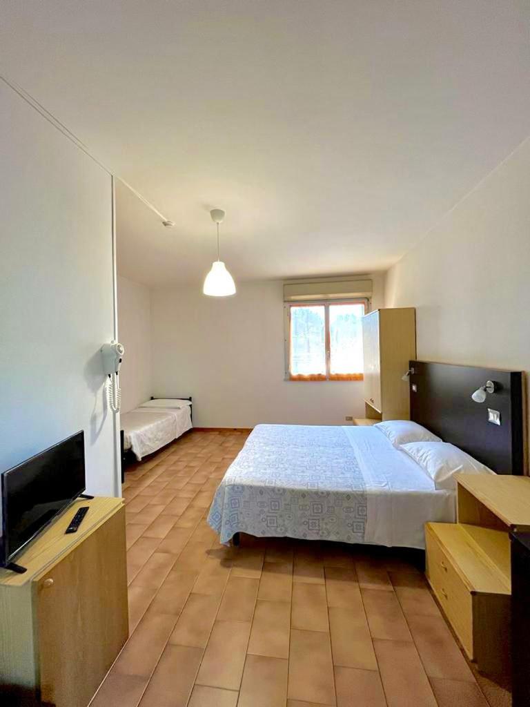 une chambre avec un lit et une télévision à écran plat dans l'établissement Hotel Nazionale, à Milano Marittima 51 autres photos