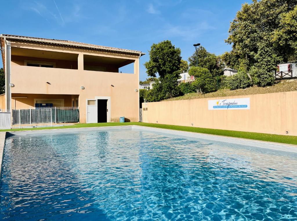 une piscine devant une maison dans l'établissement Charmant Chalet avec terrasse et accès piscine., à Rocbaron