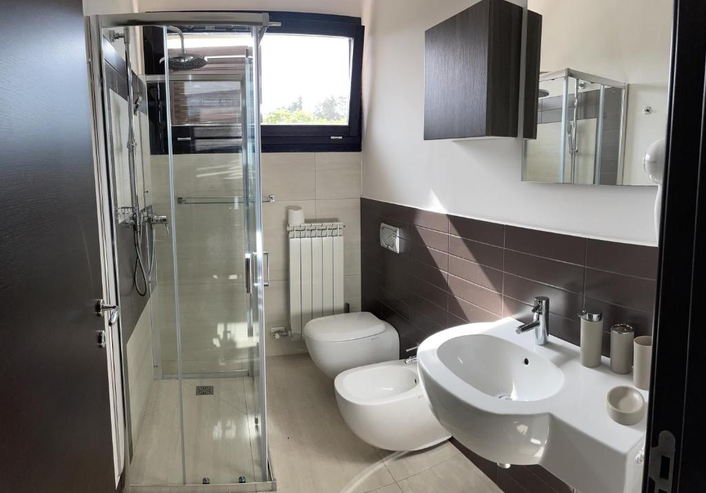 une salle de bain avec toilettes, lavabo et douche dans l'établissement La Casa di Flò Luxury Rooms, à Alezio