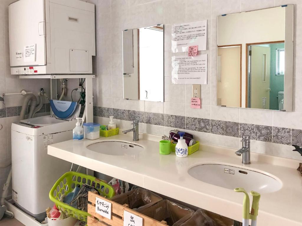une cuisine avec deux lavabos et un lave-linge/sèche-linge dans l'établissement Minshuku Irayoi, à Ishigaki