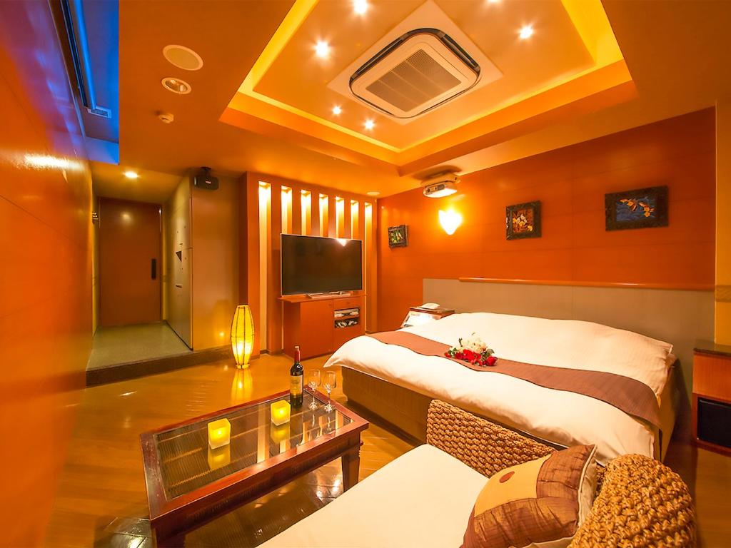 une chambre d'hôtel avec un lit et un canapé dans l'établissement Hotel Rocco (Adult Only), à Nara