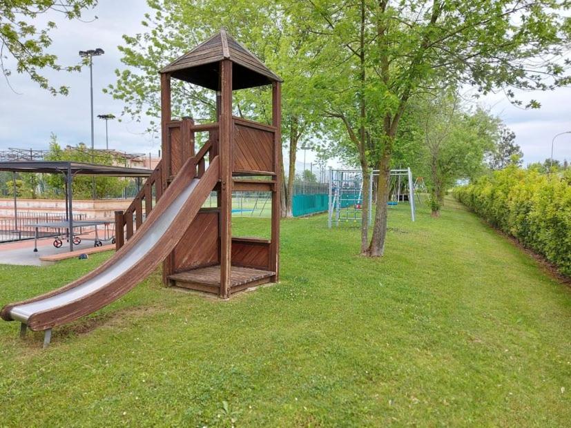 une aire de jeux avec un toboggan dans un parc dans l'établissement Garda Resort Village I Borghi, à Peschiera del Garda