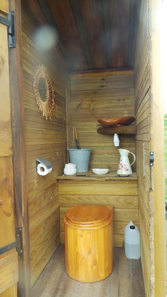 Cette petite chambre en bois comprend une table et un tonneau. dans l'établissement LOVE HORIZON, à Monprimblanc