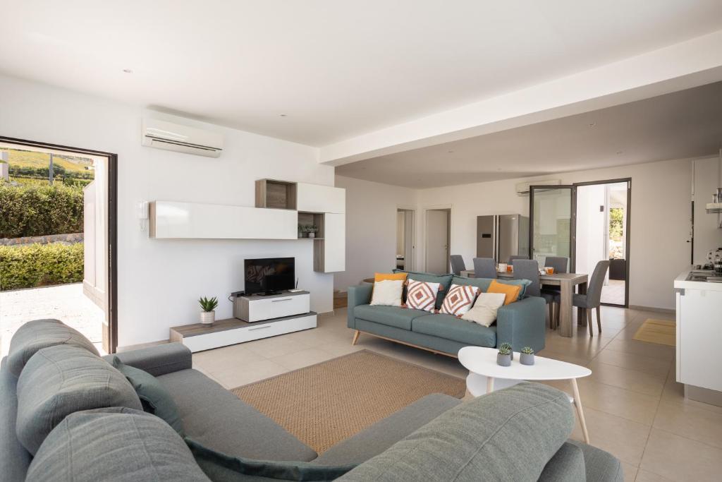 un salon avec un canapé et une cheminée dans l'établissement Grande Villa privata con piscina a Scopello, à Castellammare del Golfo