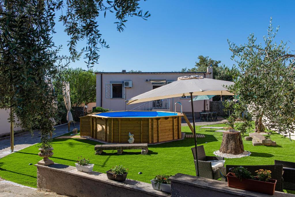 - un jardin avec une tente et un parasol dans l'établissement La Piccola Villetta con il grande Giardino, à Rome