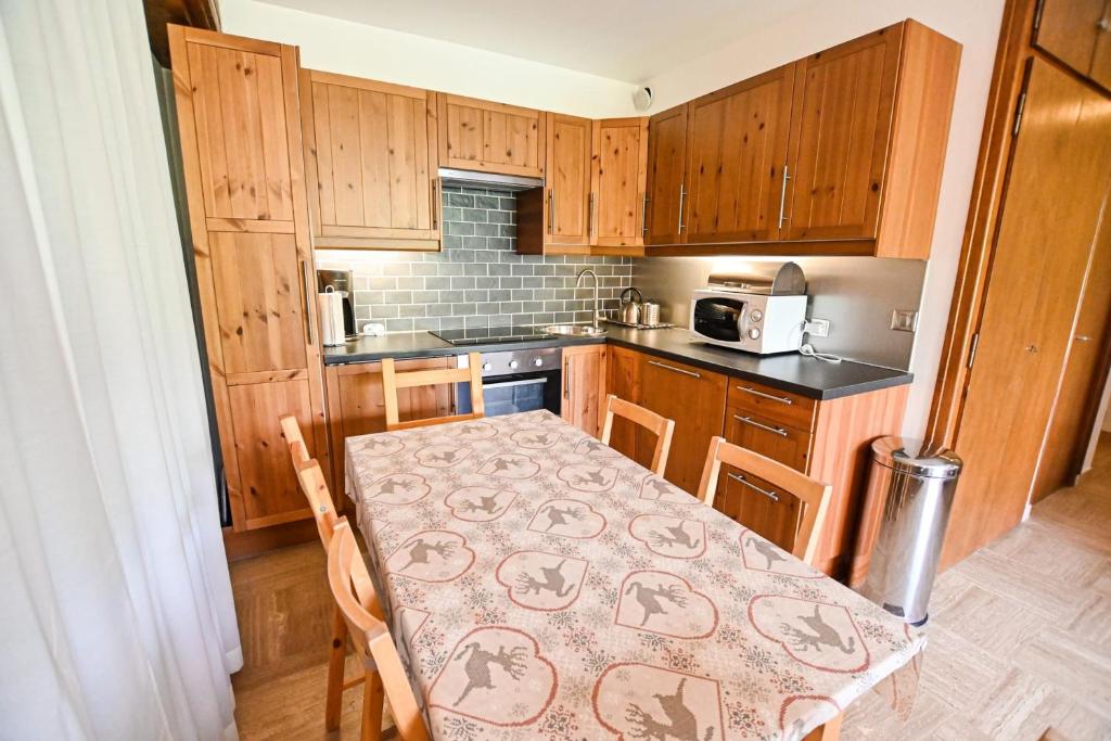 - une petite cuisine avec une table ornée d'un motif dans l'établissement Charmant 50m avec BALCON à Megève !, à Megève