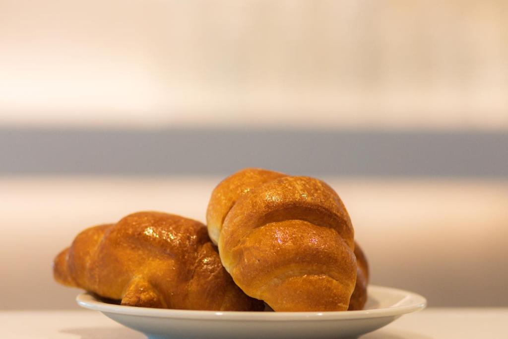 trois beignets assis sur une plaque sur une table dans l'établissement Hotel Felicioni, à Pineto