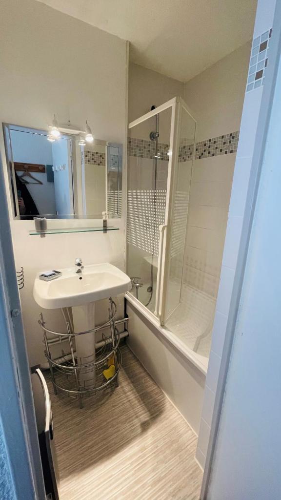 une salle de bain blanche avec un lavabo et une douche dans l'établissement Appartement 4 personnes Puy St Vincent 1700, à Puy-Saint-Vincent