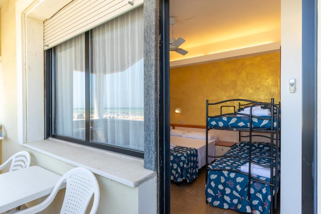 Elle comprend un balcon avec deux lits superposés et une fenêtre. dans l'établissement Hotel Montmartre, à Rimini 160 autres photos