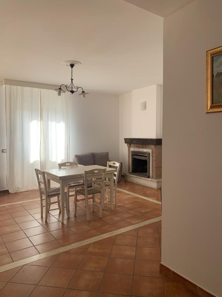 une salle à manger avec une table et des chaises et une cheminée dans l'établissement Relais Gregorio 2, à Paternopoli