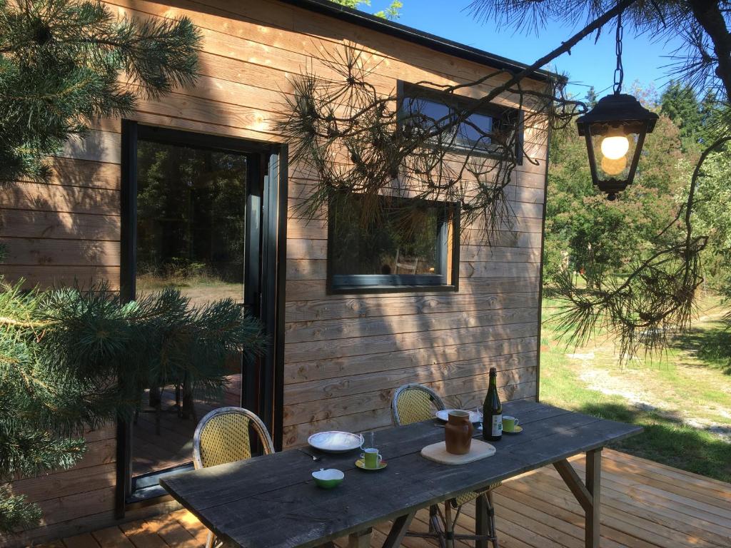 - une table avec une bouteille de vin sur la terrasse dans l'établissement La pause tiny, à Ploërmel