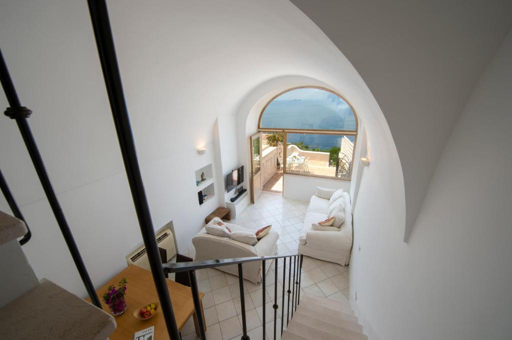 Un escalier en colimaçon mène au salon offrant une vue sur l'océan. dans l'établissement Seventh Heaven Praiano, à Praiano
