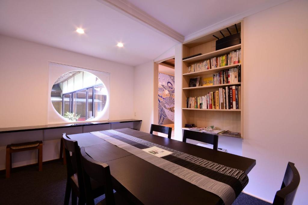 une salle à manger avec une table et une étagère à livres dans l'établissement Koyasan Shukubo Saizenin, à Koyasan 37 autres photos
