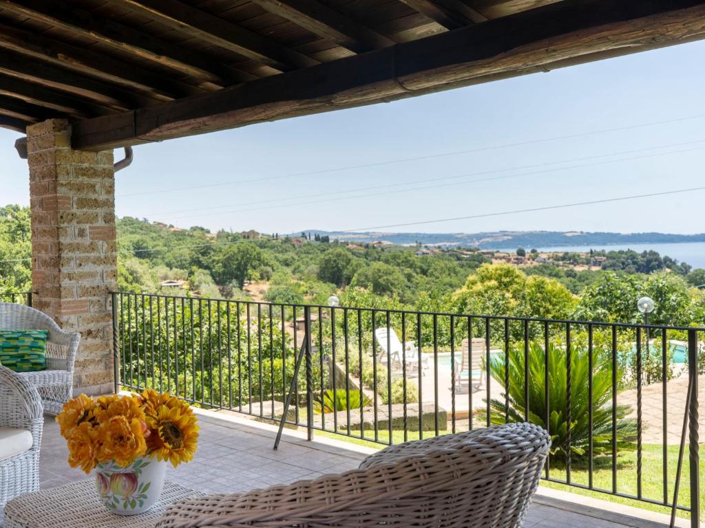 un balcon avec une table et des chaises et une vue dans l'établissement Villa Villa Bougainvillea by Interhome, à Trevignano Romano