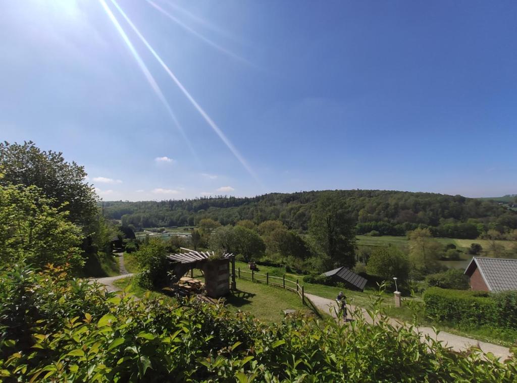 - une vue sur un parc avec un bâtiment et des arbres dans l'établissement Tente Hula, à Colleville