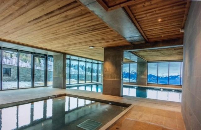 - une piscine dans un bâtiment doté de baies vitrées dans l'établissement LE RIDGE nouvelle résidence prestige - Les Arcs Paradiski, à Bourg-Saint-Maurice