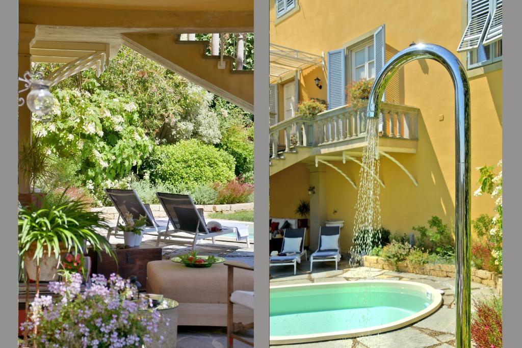 une terrasse avec un bain à remous et une maison dans l'établissement Villa Carlotta con piscina, à Lari
