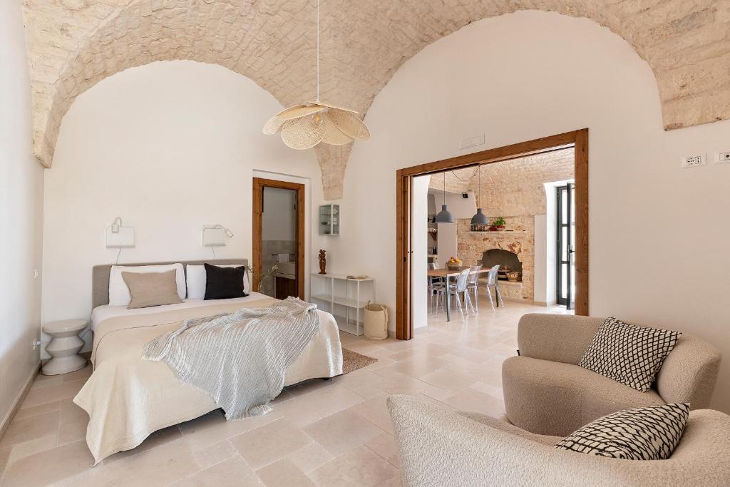 une chambre avec un lit, un canapé et une chaise dans l'établissement Vilaa Isa Beautiful Villa and trullo in Ostuni, à Ostuni 34 autres photos