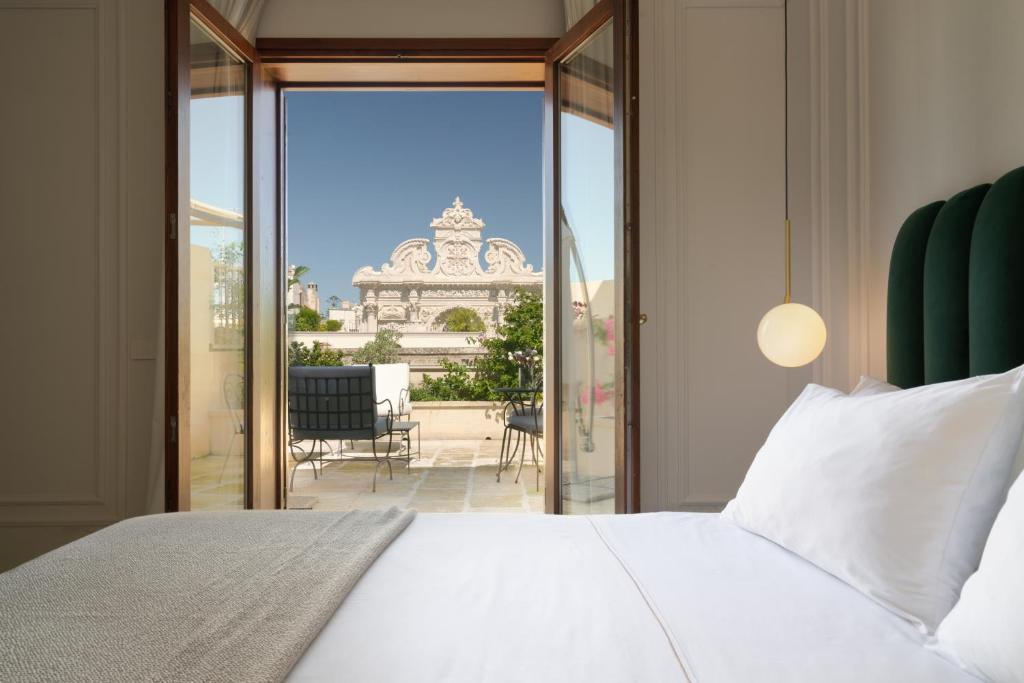 une chambre avec un lit et une vue sur un balcon dans l'établissement Patria Palace Lecce - The Leading Hotels of The World, à Lecce 53 autres photos