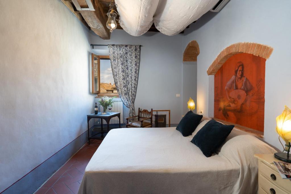 une chambre avec un lit et un tableau au mur dans l'établissement Villa Fracassini, à Pergine Valdarno 38 autres photos