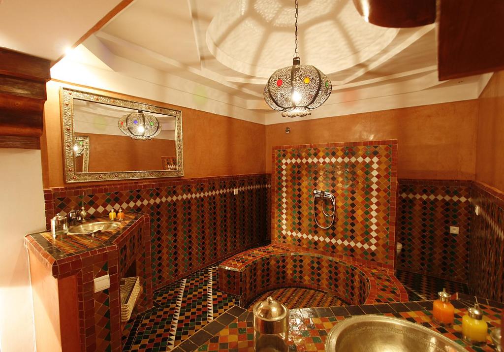 une salle de bain avec un lavabo et un miroir dans l'établissement Riad Moullaoud, à Marrakech