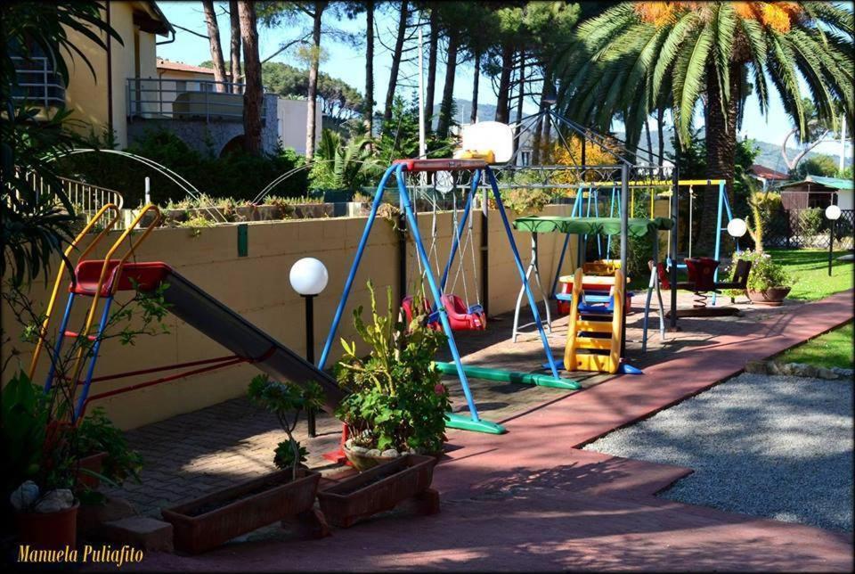 un parc avec une aire de jeux avec un toboggan dans l'établissement Hotel Anfora, à Capoliveri