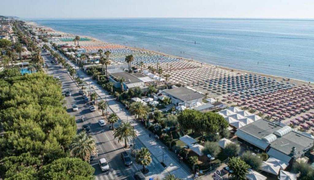 une vue aérienne d'une plage avec des voitures garées dans l'établissement Relais Concorde, à Grottammare