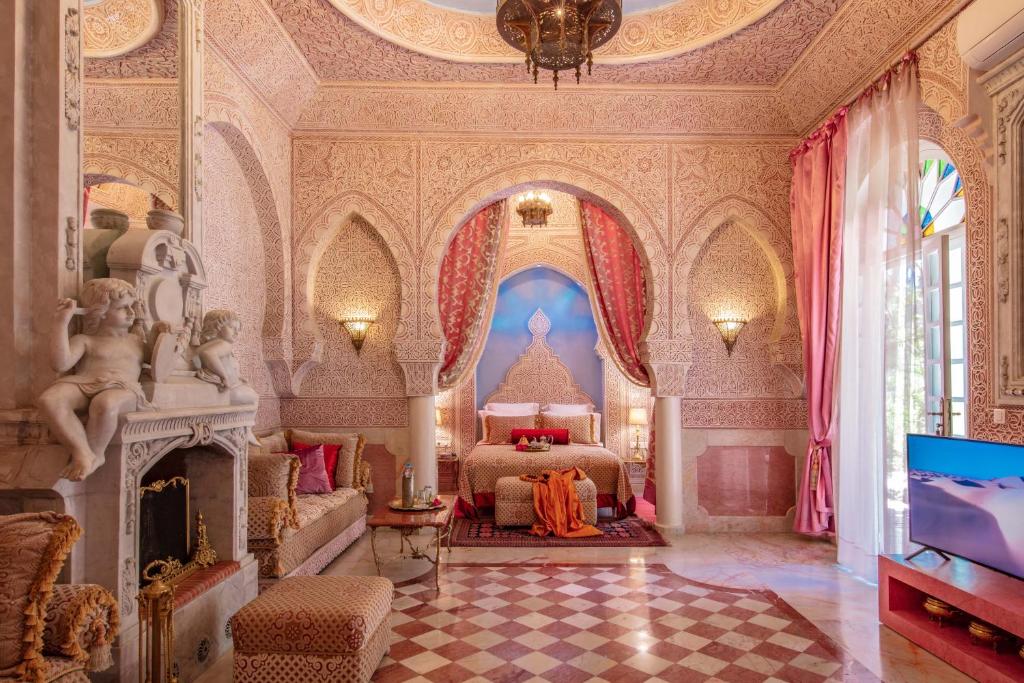 une chambre avec un lit et une télévision dans une pièce dans l'établissement Riad Dar El Malaika, à El Jadida