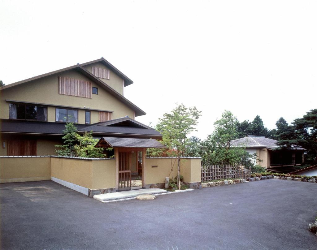 une maison avec un parking en face de celle-ci dans l'établissement Ryokan Kiritani Hakoneso, à Hakone