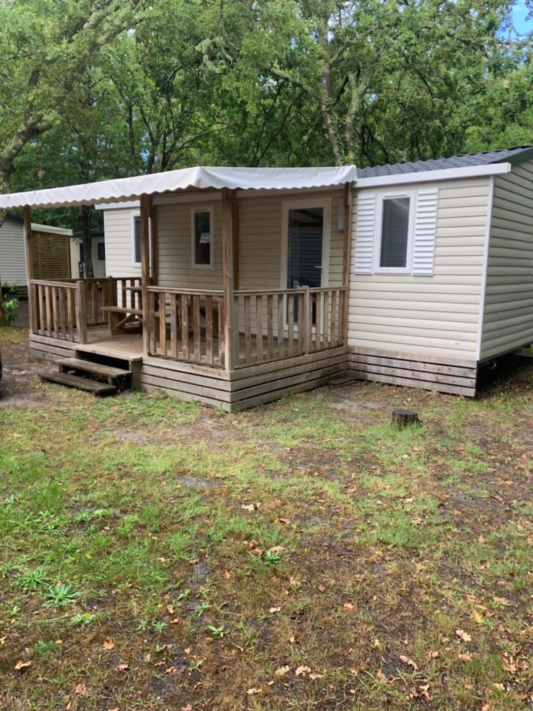 un mobil-home avec un porche et une terrasse dans l'établissement Mobil home 6 personnes camping 4* Mimizan, à Aureilhan
