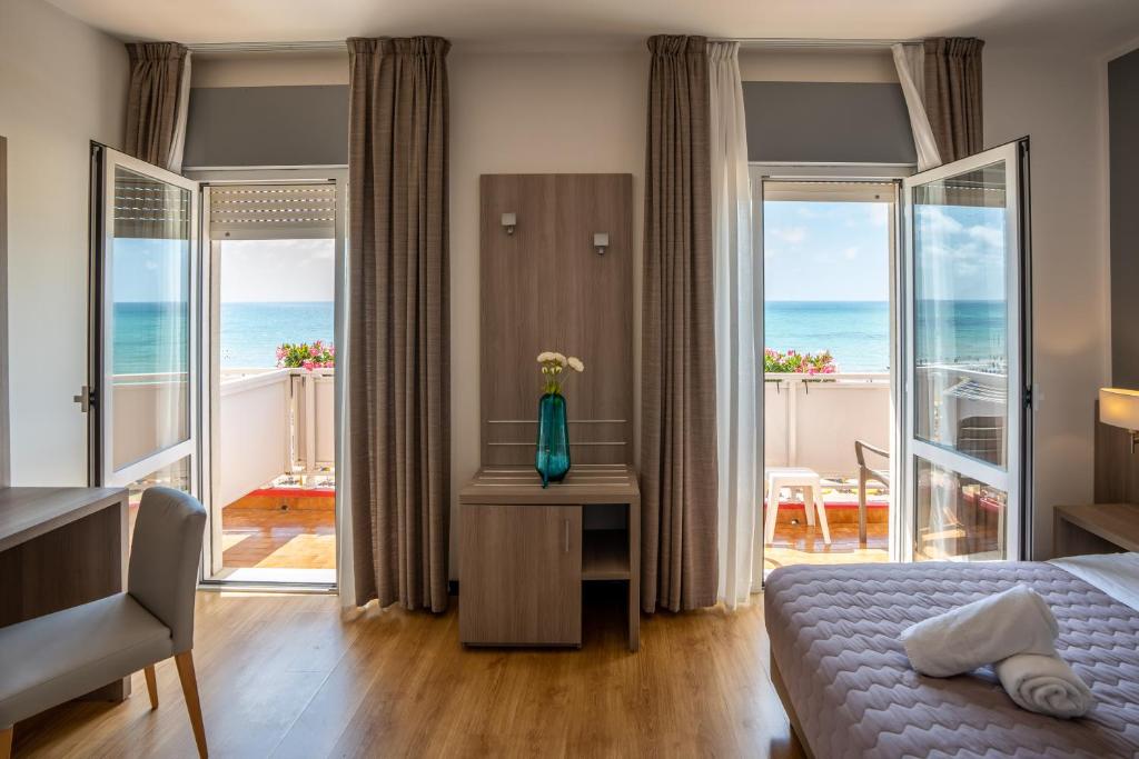 une chambre avec un lit et une vue sur l'océan dans l'établissement Hotel Loreley, à Lido di Jesolo