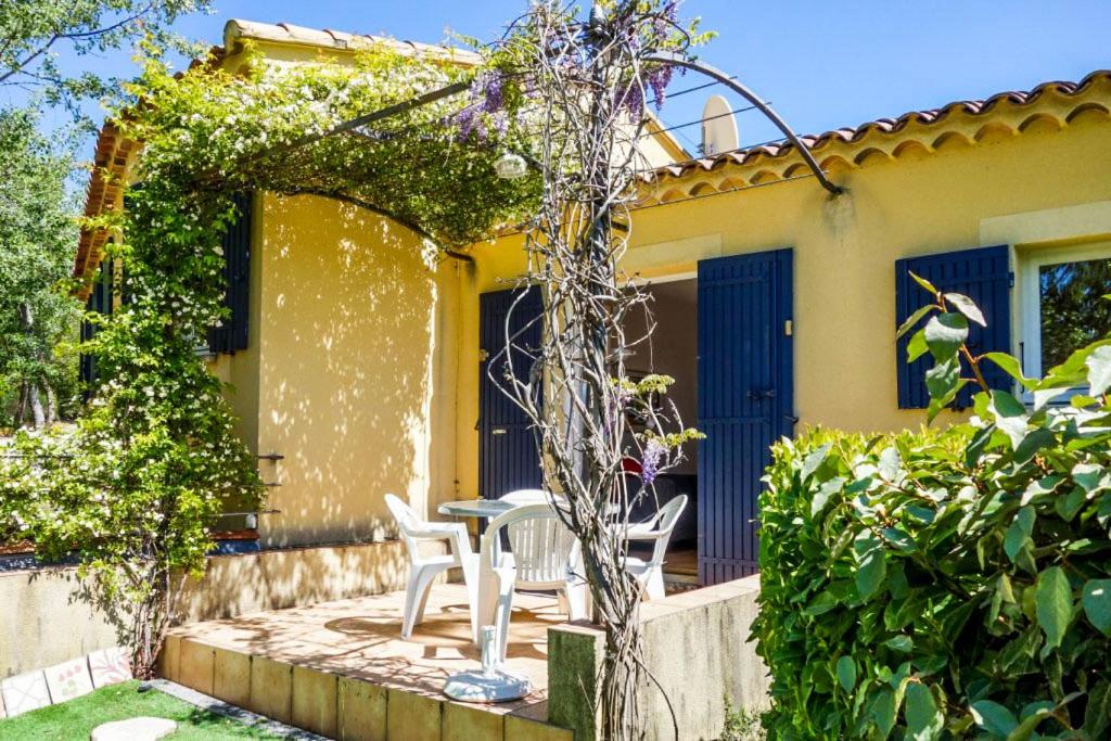 un patio avec une table et des chaises devant une maison dans l'établissement La Françonne Blanc - Gîte de charme en Provence, à Mirabel-aux-Baronnies