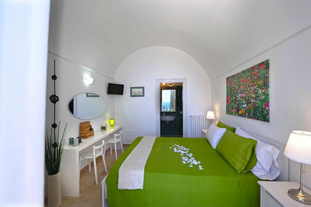 - une chambre avec un lit vert et un bureau dans l'établissement Villa Knight, à Amalfi 45 autres photos